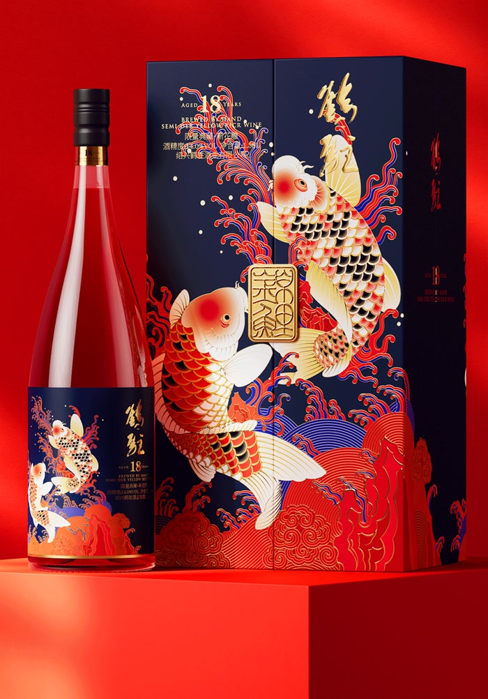Against a red background and red surface, a clear bottle on the left and a navy double-door box on the right, both carrying red and gold carp